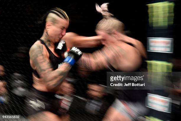 Bec Rawlings of Australia punches Ashlee Evans-Smith in their women's flyweight bout during the UFC 223 event inside Barclays Center on April 7, 2018...