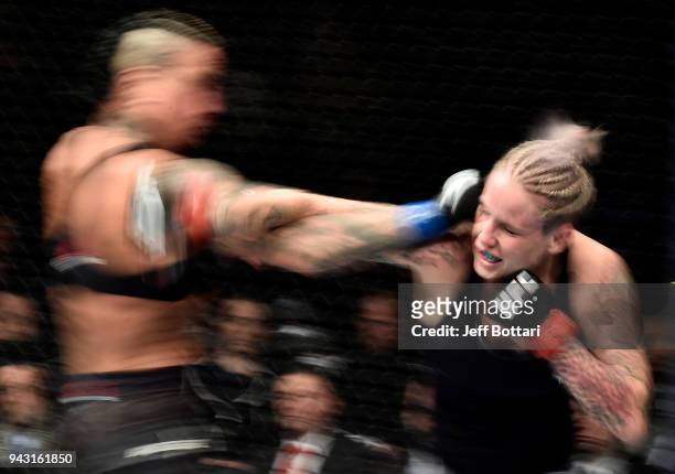 Bec Rawlings of Australia and Ashlee Evans-Smith trade punches in their women's flyweight bout during the UFC 223 event inside Barclays Center on...