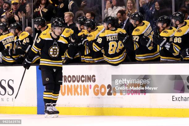 Danton Heinen of the Boston Bruins celebrates with teammates after scoring a goal against the Ottawa Senators during the second period at TD Garden...