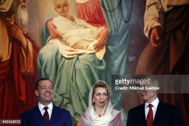 Russian President Vladimir Putin , Prime Minister Dmitry Medvedev and his wife Svetlana Medvedeva smile during the Orthodox Easter service in the...