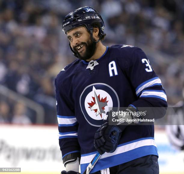 Dustin Byfuglien of the Winnipeg Jets smiles after narrowly missed scoring against the Chicago Blackhawks during NHL action on April 7, 2018 at Bell...