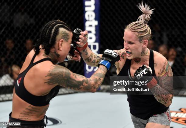 Bec Rawlings of Australia punches Ashlee Evans-Smith in their women's flyweight bout during the UFC 223 event inside Barclays Center on April 7, 2018...