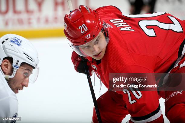 Sebastian Aho of the Carolina Hurricanes and Tyler Johnson of the Tampa Bay Lightning prepare for a faceoff during an NHL game on April 7, 2018 at...