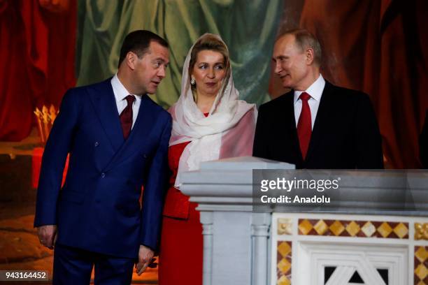 Russia's Prime Minister Dmitry Medvedev , his wife Svetlana and Russia's President Vladimir Putin attend the Orthodox Easter service at the Cathedral...