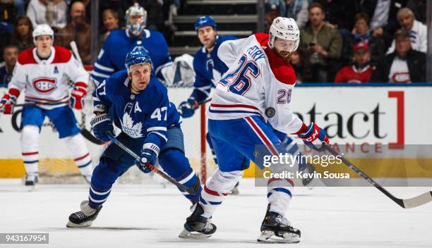 Leo Komarov of the Toronto Maple Leafs skates against Jeff Petry of the Montreal Canadiens during the second period at the Air Canada Centre on April...