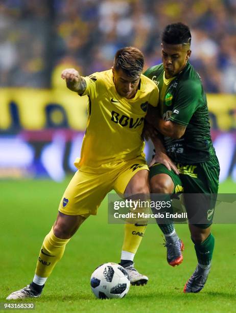 Julio Buffarini of Boca Juniors fights for the ball with Nicolas Fernandez of Defensa y Justicia during a match between Boca Juniors and Defensa y...