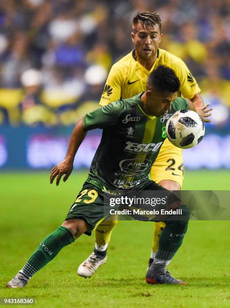 Julio Buffarini of Boca Juniors fights for the ball with Nicolas Fernandez of Defensa y Justicia during a match between Boca Juniors and Defensa y...