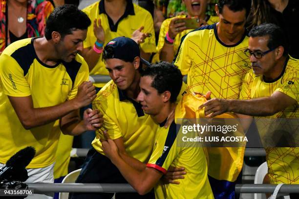 Colombian tennis player Daniel Galan celebrates with teammates after defeating Brazilian tennis player Thiago Monteiro during their Americas Zone...