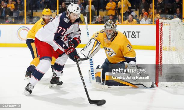 Pekka Rinne of the Nashville Predators eyes the puck on the stick of Josh Anderson of the Columbus Blue Jackets during an NHL game at Bridgestone...