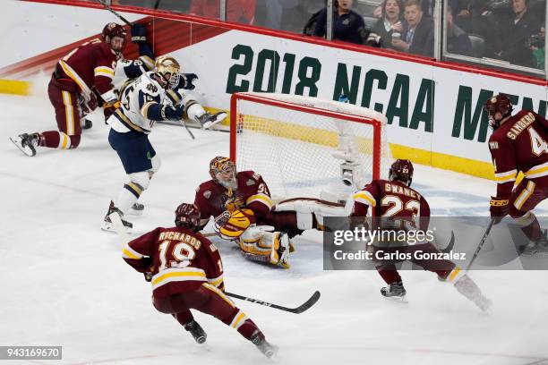Andrew Oglevie of the Notre Dame Fighting Irish scores a goal past Hunter Shepard of the Minnesota-Duluth Bulldogs during the Division I Men's Ice...