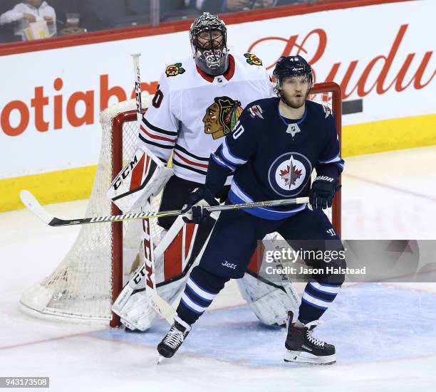 Joel Armia of the Winnipeg Jets screens Jeff Glass of the Chicago Blackhawks during NHL action on April 7, 2018 at Bell MTS Place in Winnipeg,...