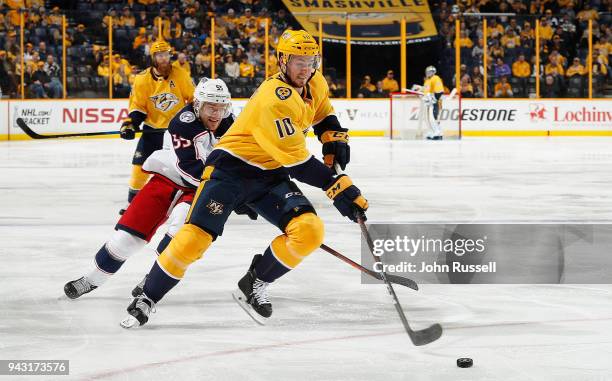 Colton Sissons of the Nashville Predators drives to the net against Mark Letestu of the Columbus Blue Jackets during an NHL game at Bridgestone Arena...