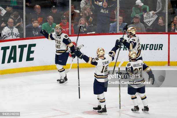 Andrew Oglevie of the Notre Dame Fighting Irish scores a goal past Hunter Shepard of the Minnesota-Duluth Bulldogs during the Division I Men's Ice...