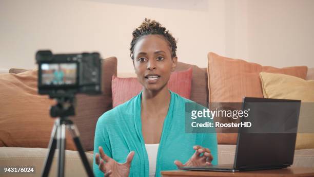 beautiful african-american vlogger recording livestream for her show - medium shot stock pictures, royalty-free photos & images