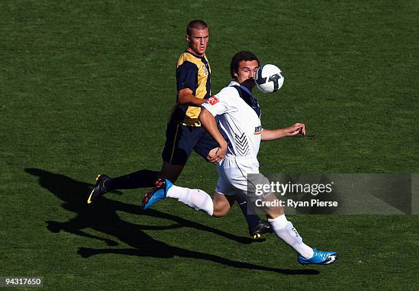 Matthew Demo of the Victory wins the ball over Emmanuel Giannaros of the Mariners during the round 14 National Youth League match between the Central...