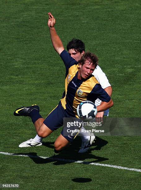 Nicholas Fitzgerald of the Mariners is tackled by Stephen Hatzikostas of the Victory during the round 14 National Youth League match between the...