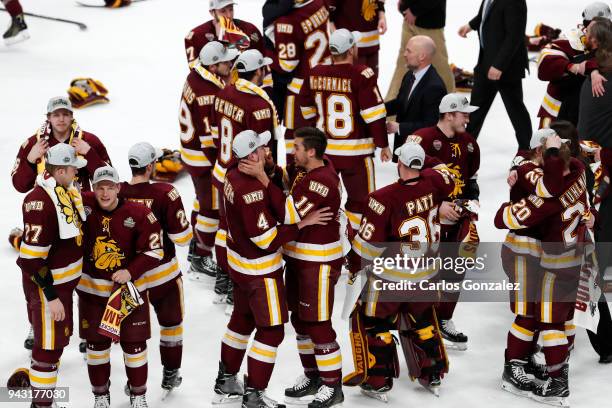 The Minnesota-Duluth Bulldogs celebrate their victory over the Notre Dame Fighting Irish during the Division I Men's Ice Hockey Semifinals held at...