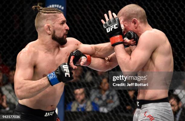 Chris Gruetzemacher punches Joe Lauzon in their lightweight bout during the UFC 223 event inside Barclays Center on April 7, 2018 in Brooklyn, New...