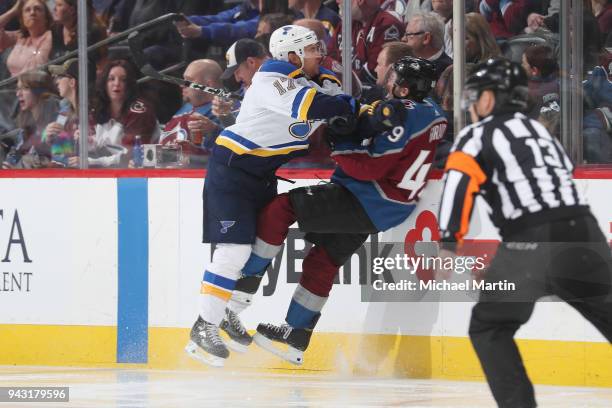 Jaden Schwartz of the St. Louis Blues knocks Samuel Girard of the Colorado Avalanche to the ice at the Pepsi Center on April 2018 in Denver, Colorado.