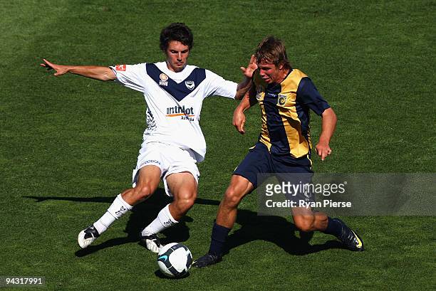 Nicholas Fitzgerald of the Mariners tackles Matthew Theodore of the Victory during the round 14 National Youth League match between the Central Coast...