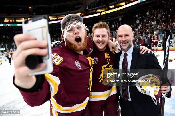 The Minnesota-Duluth Bulldogs celebrate their victory over the Notre Dame Fighting Irish during the Division I Men's Ice Hockey Semifinals held at...