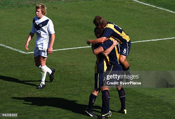 Nicholas Fitzgarald congratulates Brady Smith of the Mariners after scoring his team's first goal during the round 14 National Youth League match...
