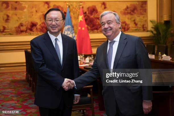 Chinese state councilor Yang Jiechi shakes hands with United Nations Secretary General-designate Antonio Guterres at Zhongnanhai on April 8, 2018 in...