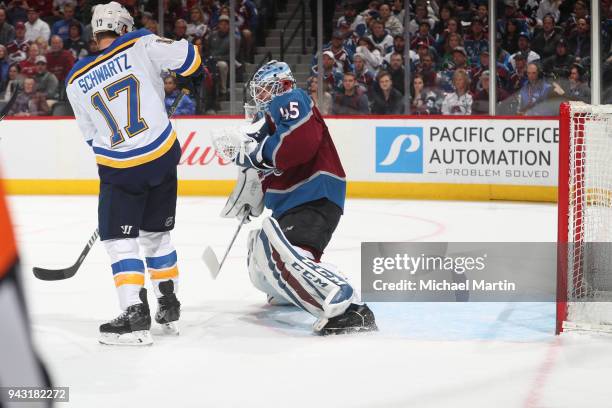Jaden Schwartz of the St. Louis Blues deflects a shot past goaltender Jonathan Bernier of the Colorado Avalanche at the Pepsi Center on April 2018 in...