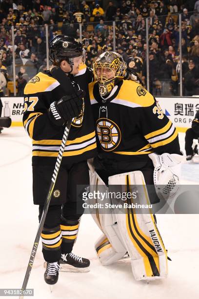Tommy Wingels and Anton Khudobin of the Boston Bruins hug after the win against the Ottawa Senators at the TD Garden on April 7, 2018 in Boston,...