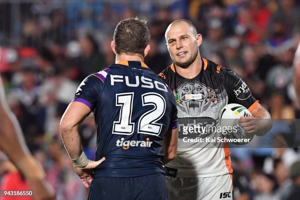 Ryan Hoffman of the Storm and Robbie Rochow of the Tigers shake hands following the round five NRL match between the Wests Tigers and the Melbourne...
