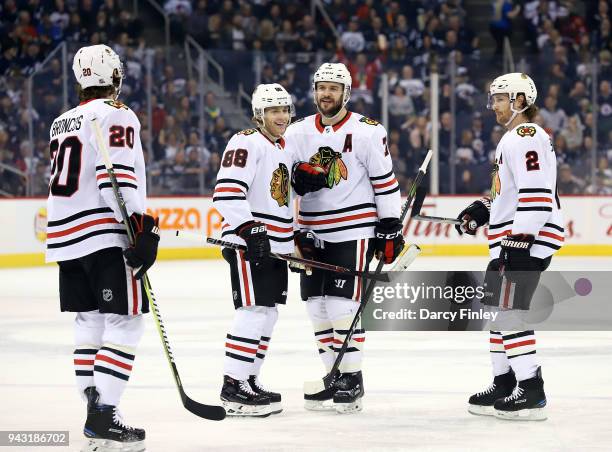 Brandon Saad, Patrick Kane, Brent Seabrook and Duncan Keith of the Chicago Blackhawks celebrate a second period goal against the Winnipeg Jets at the...