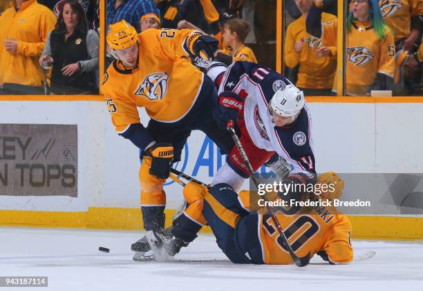 Alexei Emelin and Miikka Salomaki of the Nashville Predators sandwhich Matt Calvert of the Columbus Blue Jackets during the third period at...