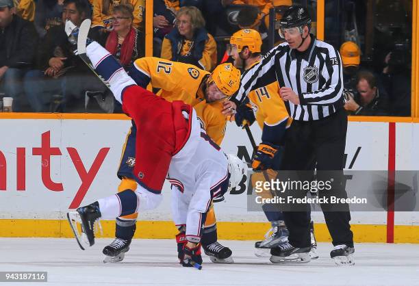 Mike Fisher of the Nashville Predators flips Pierre-Luc Dubois of the Columbus Blue Jackets during the third period at Bridgestone Arena on April 7,...