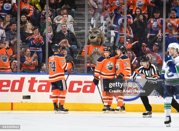 Ethan Bear, Kris Russell and Ryan Nugent-Hopkins of the Edmonton Oilers celebrate after a goal during the game against the Vancouver Canucks on April...