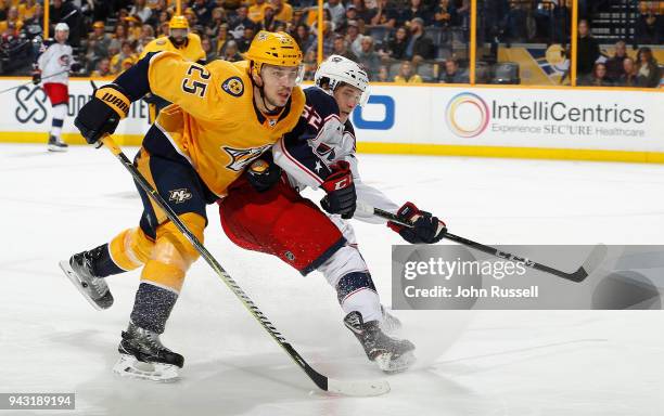 Alexei Emelin of the Nashville Predators battles against Alex Broadhurst of the Columbus Blue Jackets during an NHL game at Bridgestone Arena on...