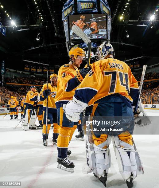 Filip Forsberg congratulates Juuse Saros of the Nashville Predators after a 4-2 win against the Columbus Blue Jackets during an NHL game at...