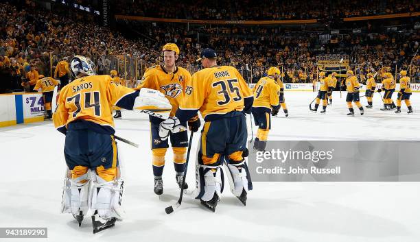 Ryan Johansen celebrates a win with Juuse Saros and Pekka Rinne of the Nashville Predators against the Columbus Blue Jackets during an NHL game at...