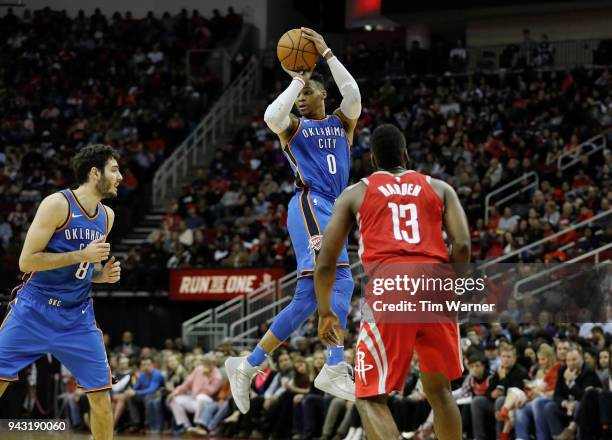 Russell Westbrook of the Oklahoma City Thunder looks to pass the ball in the second half defended by James Harden of the Houston Rockets at Toyota...