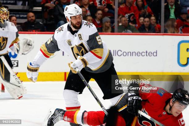 Micheal Ferland of the Calgary Flames is checked by Deryk Engelland of the Vegas Golden Knights during an NHL game on April 7, 2018 at the Scotiabank...