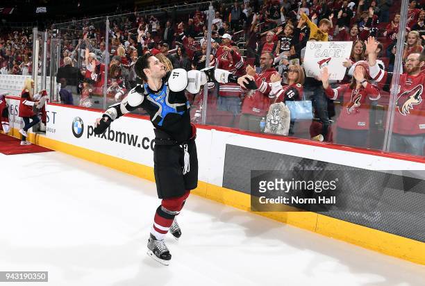 Oliver Ekman-Larsson of the Arizona Coyotes throws t-shirts into the crowd as part of Fan Appreciation Night following the final game of the season...