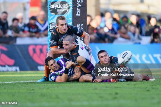 Nelson Asofa-Solomona of the Storm, Jacob Liddle of the Tigers, Russell Packer of the Tigers and Tuimoala Lolohea of the Tigers compete for the ball...