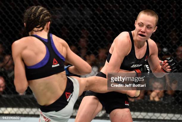 Joanna Jedrzejczyk of Poland kicks Rose Namajunas in their women's strawweight title bout during the UFC 223 event inside Barclays Center on April 7,...