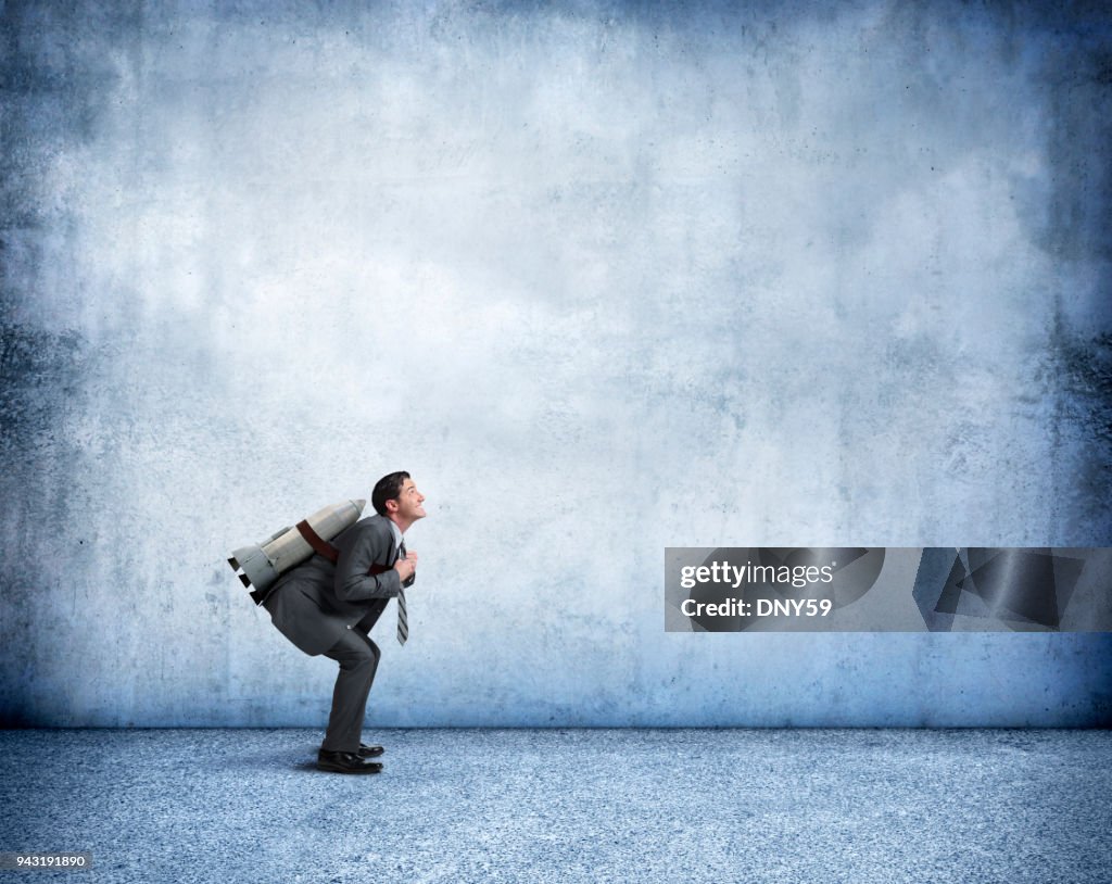 Businessman With Rocket Strapped To His Back