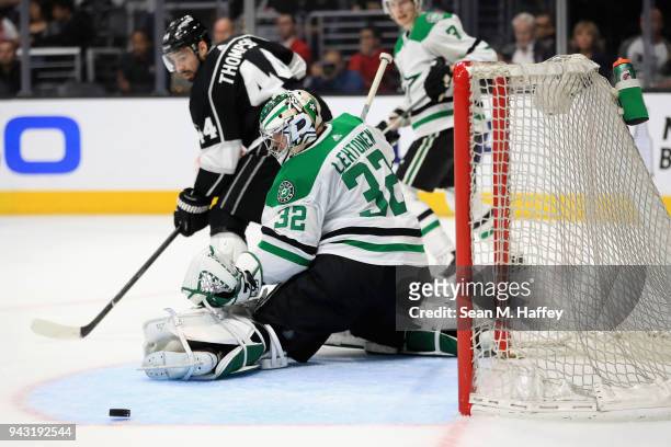 Kari Lehtonen of the Dallas Stars blocks a shot on goal as Nate Thompson of the Los Angeles Kings looks on during the second period of a game at...