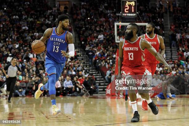 Paul George of the Oklahoma City Thunder brings the ball down the court defended by James Harden of the Houston Rockets in the second half at Toyota...