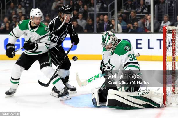 Tyler Toffoli of the Los Angeles Kings rushes the puck as Kari Lehtonen and Dan Hamhuis of the Dallas Stars defend during the second period of a game...