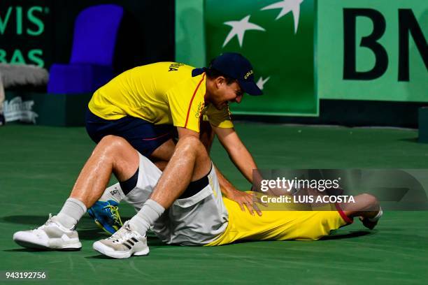 Colombian tennis player Alejandro Gonzalez celebrates with his teammate Pablo Gonzalez after defeating Brazilian tennis player Joao Sorgi during...