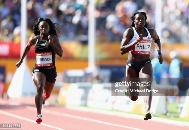 Asha Philip of England and V'Alonee Robinson of the Bahamas compete in the Women's 100 metres heats on day four of the Gold Coast 2018 Commonwealth...