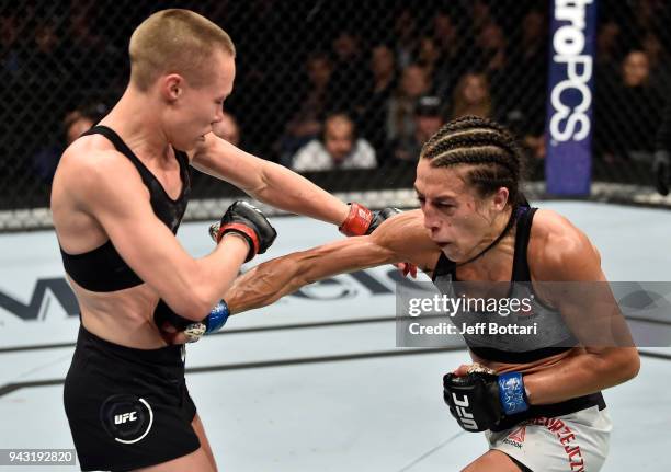 Joanna Jedrzejczyk of Poland punches the body of Rose Namajunas in their women's strawweight title bout during the UFC 223 event inside Barclays...