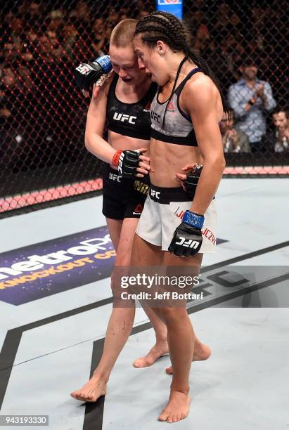 Opponents Rose Namajunas and Joanna Jedrzejczyk of Poland embrace after the conclusion of their women's strawweight title bout during the UFC 223...